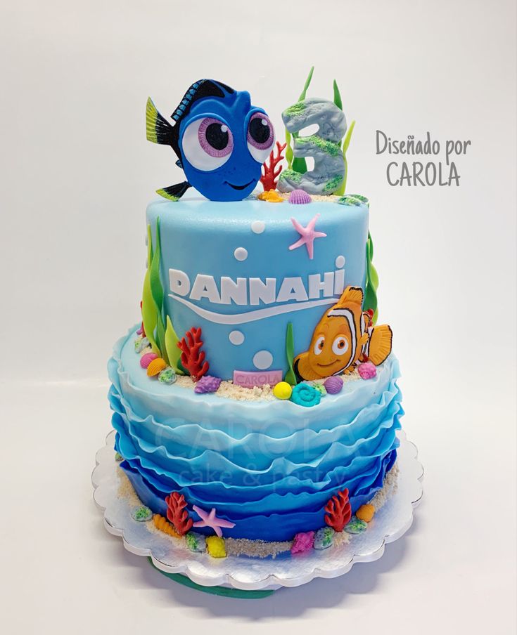 a birthday cake decorated with an image of nemo and dory fish on it