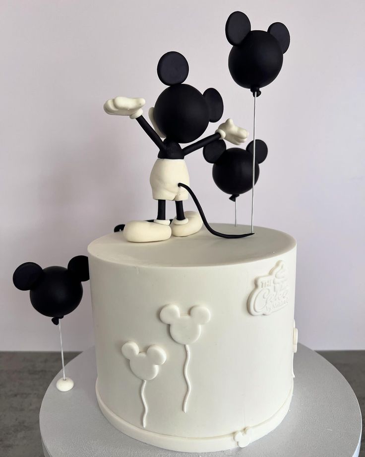 a mickey mouse cake with black and white decorations