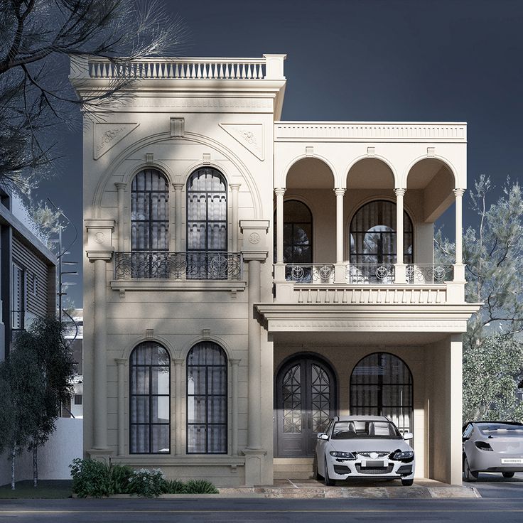 a white car parked in front of a two story building with arches and balconies