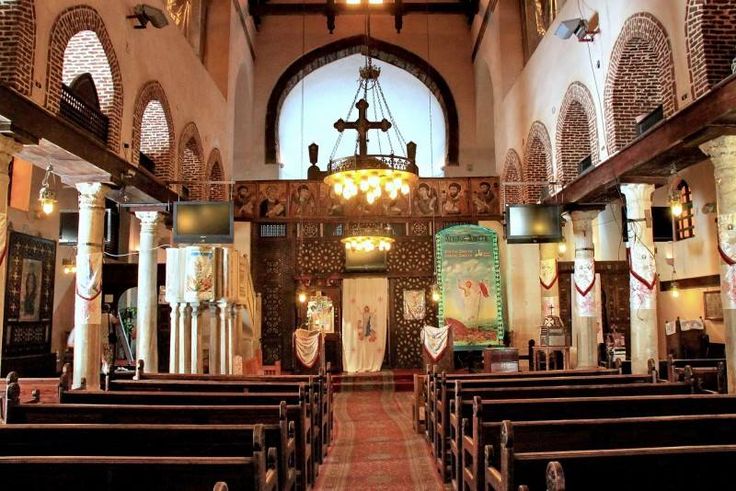 the inside of a church with pews and stained glass windows