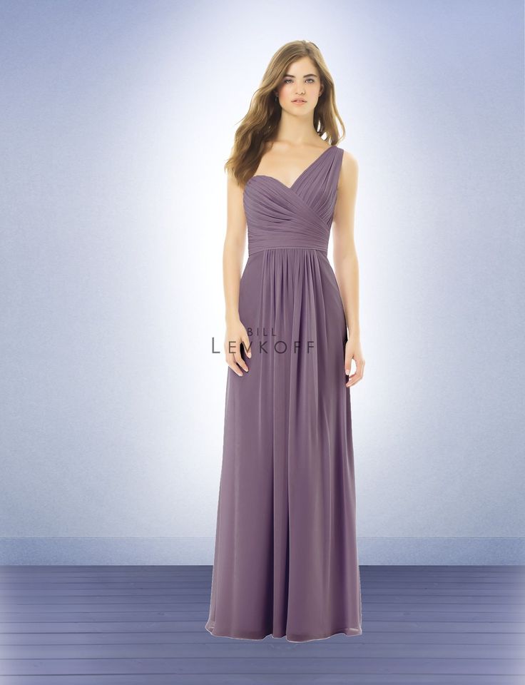 a woman in a long purple dress standing on a blue floor with her hands on her hips