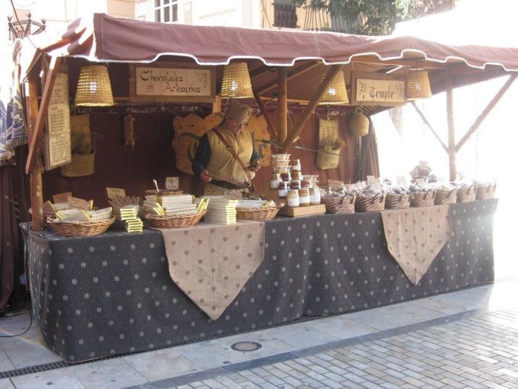 an outdoor market with baskets and food on display