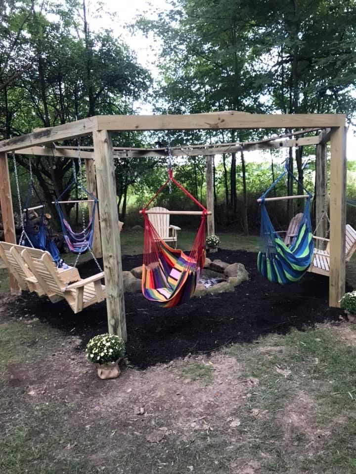 two hammocks are hanging from a wooden structure