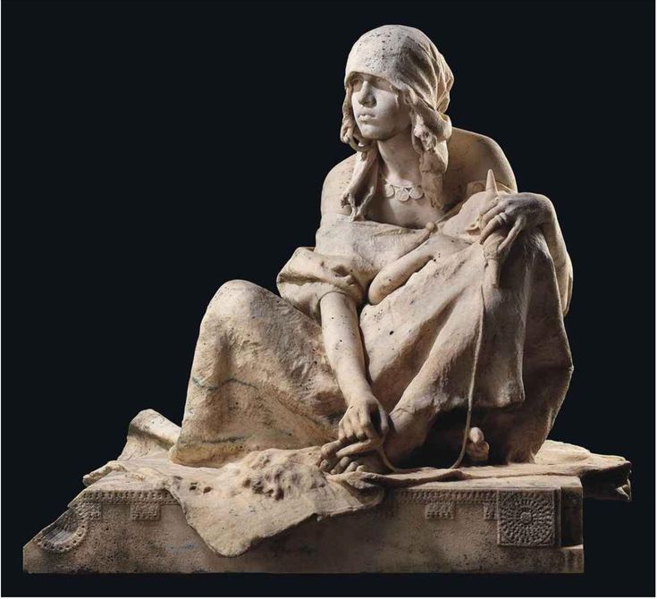 a statue of a woman sitting on top of a stone slab with her hands in her pockets