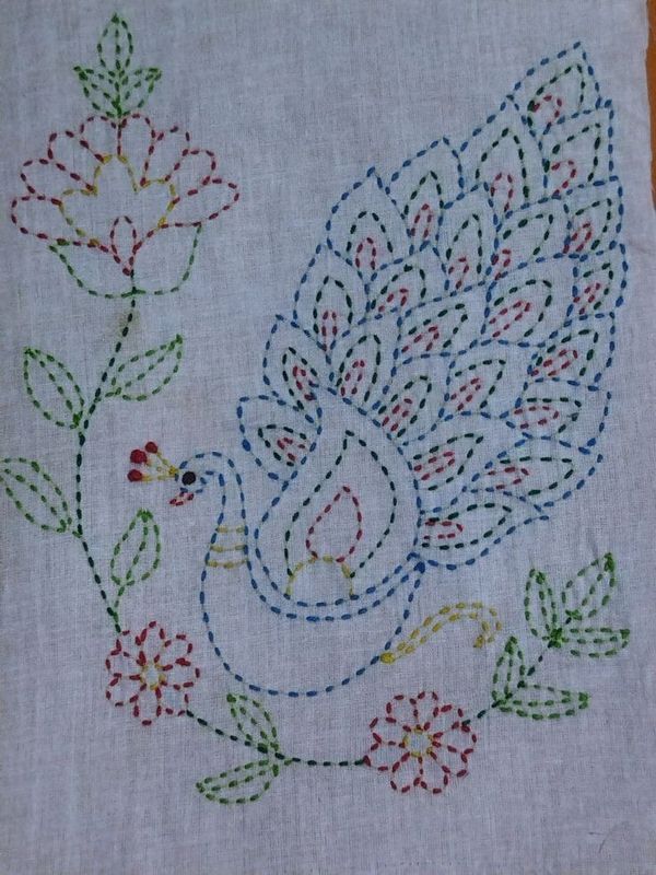 a white cloth with a peacock and flowers on it