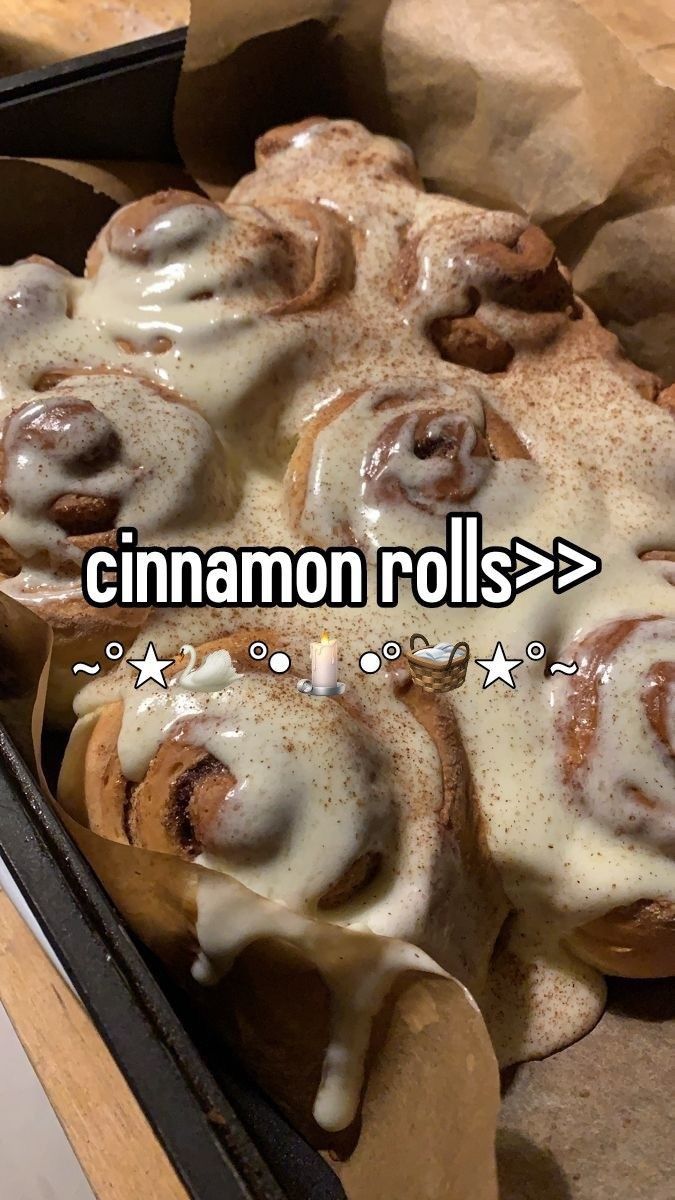 cinnamon rolls with icing on top in a pan