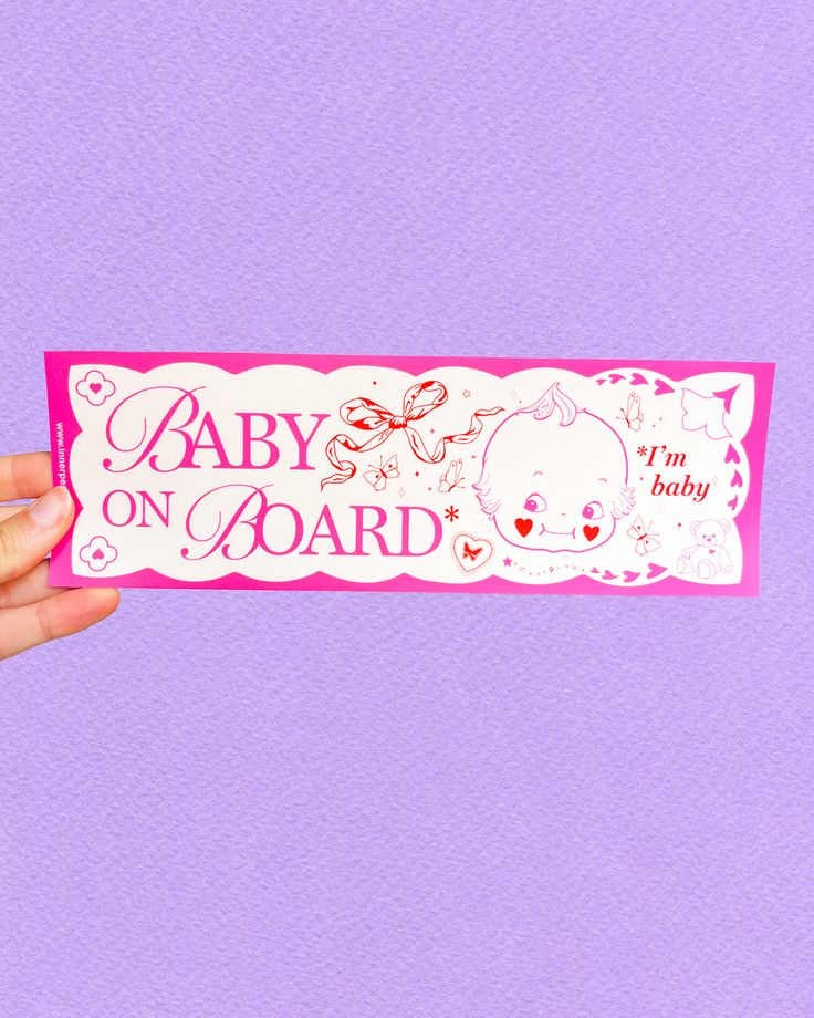 a hand holding up a baby on board sticker against a purple background that says, i'm baby