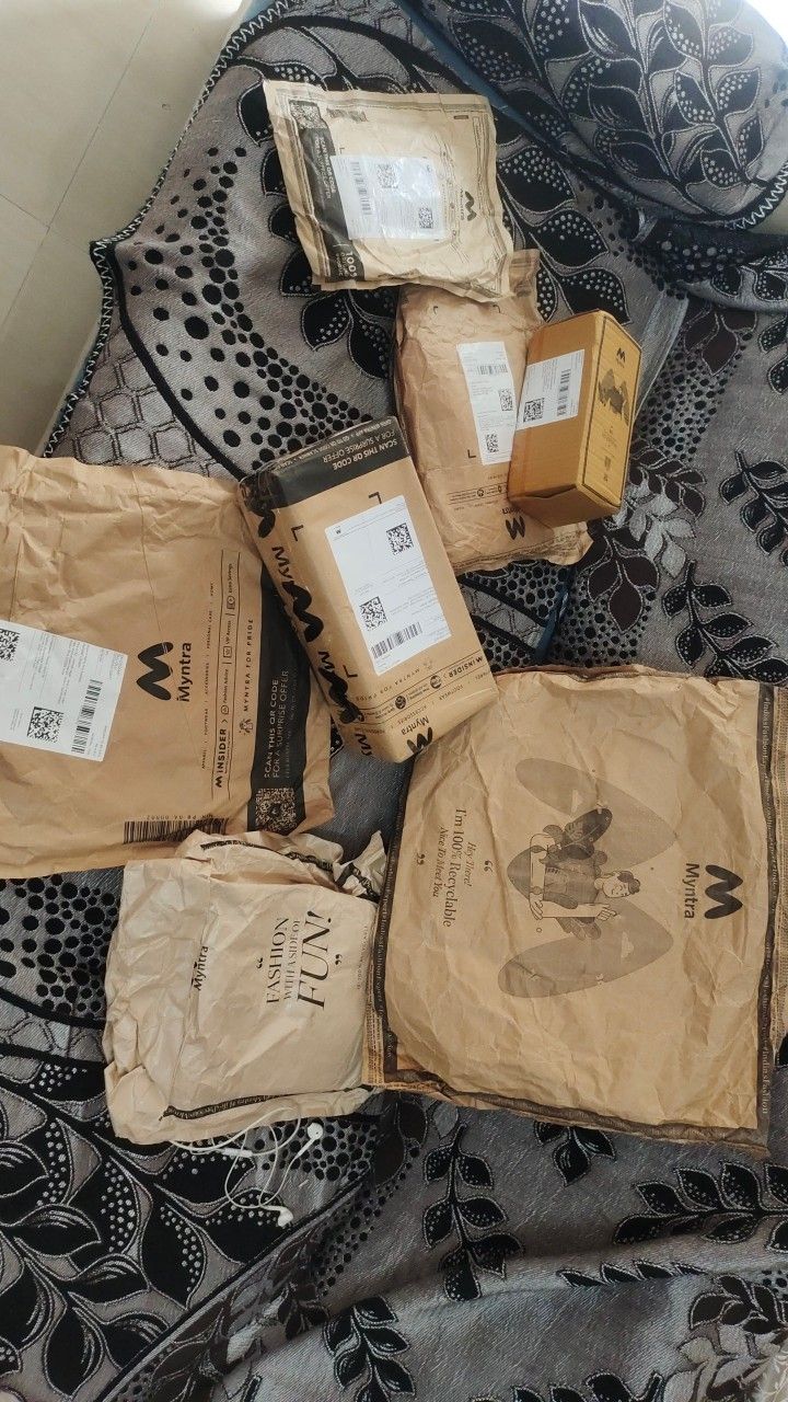 several packages are laid out on a bed