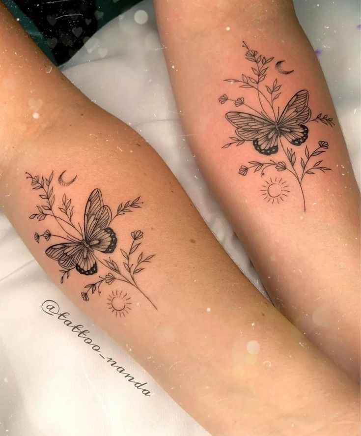 two women with tattoos on their legs sitting next to each other, both showing butterflies and flowers