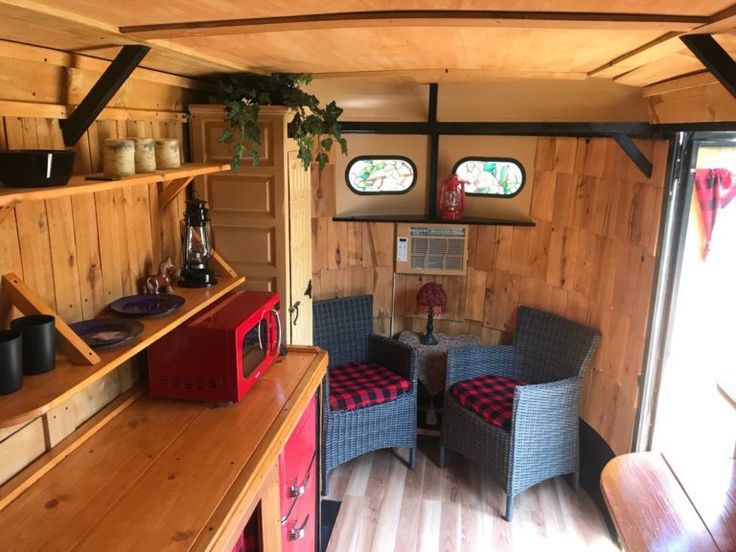 the inside of a tiny house with two chairs