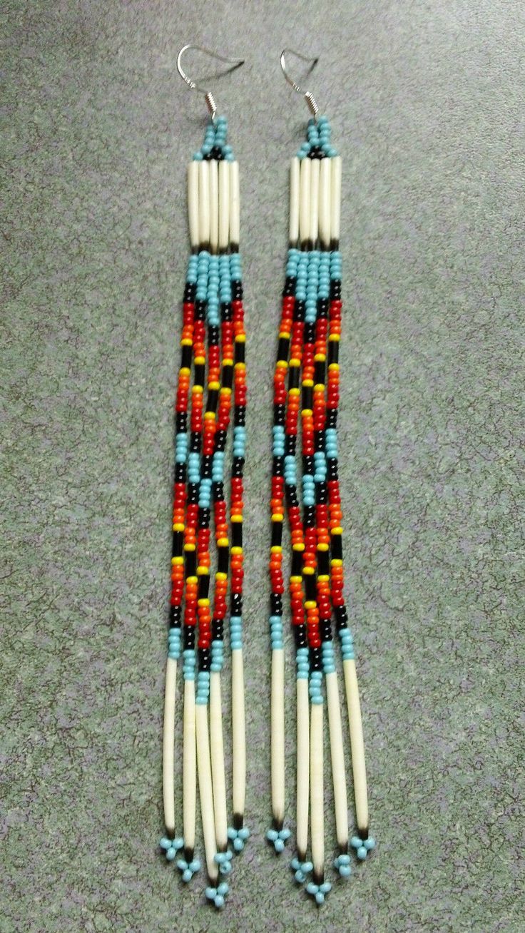 two pairs of beaded earrings sitting on top of a floor next to each other