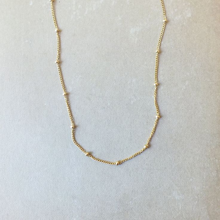 Our Satellite Chain Necklace is dainty and adds just a bit of texture. A perfect everyday necklace that looks lovely on its own and can easily layer with your other favorite necklaces. Dainty Link Chain Necklace With Clavicle Chain, Dainty Station Necklace With Delicate Chain As Gift, Dainty Clavicle Link Chain Necklace, Dainty Everyday Necklace With Chain, Minimalist Everyday Clavicle Chain Necklace, Minimalist Charm Necklaces With Delicate Chain Choker, Dainty Chain Layered Necklace For Everyday, Simple Choker Necklace With Adjustable Chain, Dainty Everyday Necklace With Beaded Chain