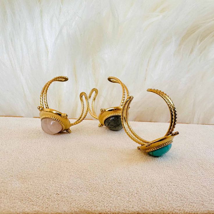 Bring some mystical vibes to your style with Earth Spirit Gem Rings! With their boho retro look, they'll add a little something special to any outfit. 🤩 And just look at those magical gems—they'll keep your spirit grounded, no matter how high your style game goes! 🤩✨ Each ring is adjustable, ensuring a perfect fit no matter the size of your finger. Slip one on and accessorize your look with a touch of classic, bohemian chic! 🥰 ✓ Material: Stainless Steel✓ Gemstone: turquoise, rose quartz, gre Adjustable Bohemian Crystal Ring With Ethical Gemstones, Bohemian Open Ring Crystal Ring For Healing, Bohemian Open Crystal Ring For Healing, Bohemian Brass Stackable Jewelry, Spiritual Adjustable Gemstone Midi Rings, Adjustable Spiritual Gemstone Midi Rings, Bohemian Adjustable Crystal Ring For Gifts, Bohemian Adjustable Crystal Ring Gift, Bohemian Adjustable Crystal Ring As Gift