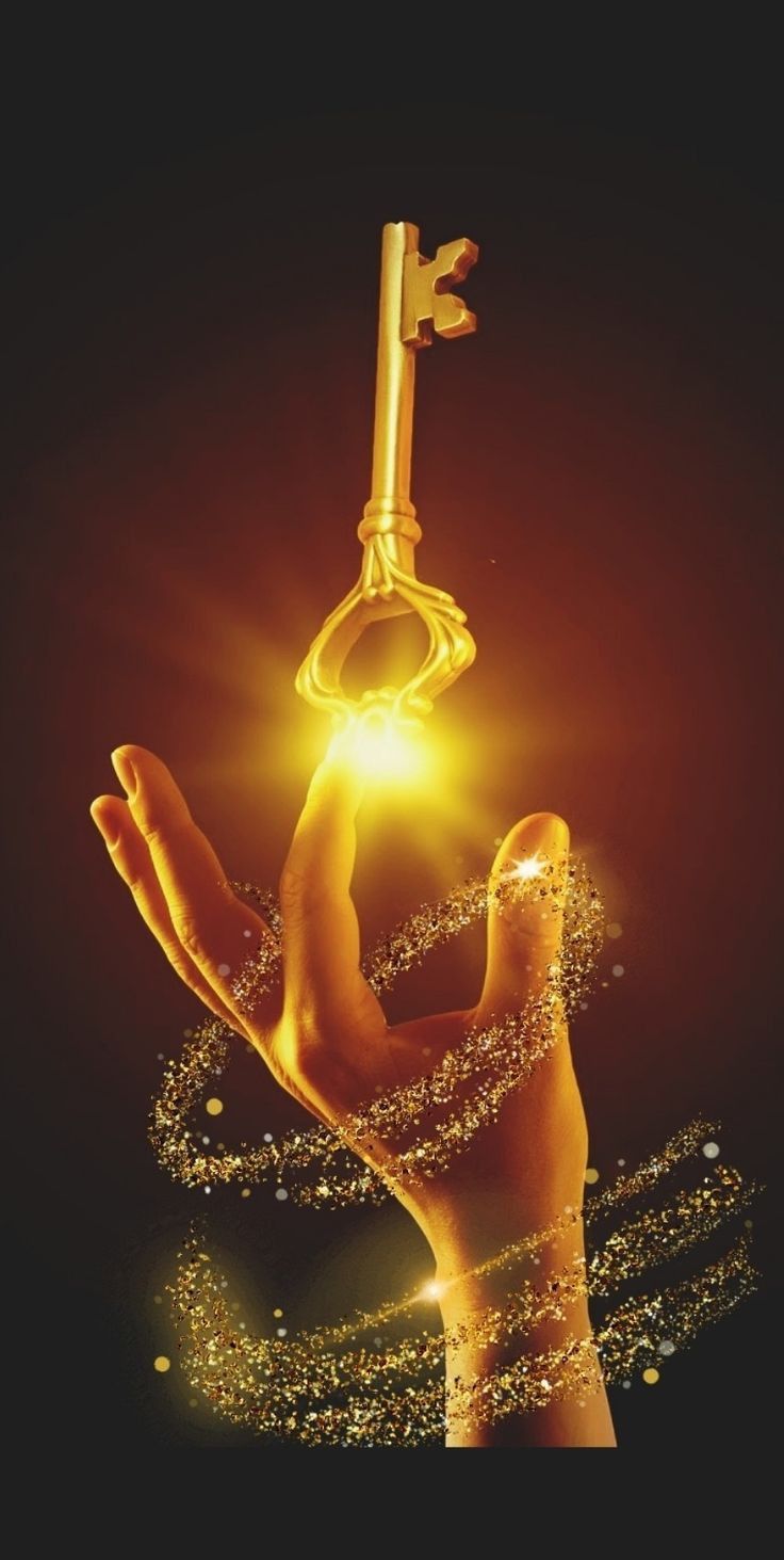 a woman's hand holding a golden key in the air with water droplets around it