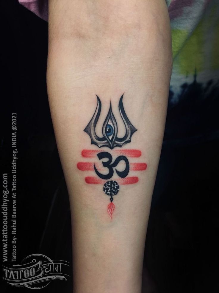 a tattoo on the leg of a person with an omen symbol in red and black