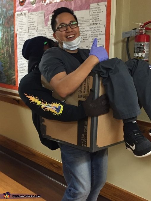 a man in a box costume holding a child