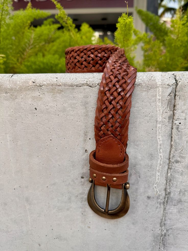 The Free People Brix Belt is a classic leather belt featuring a detailed woven band and chunky Western buckle for a chic touch. Color: Cognac, Black, Oyster Mauve 100% Leather Palm Beach Gardens Florida, Western Buckles, Palm Beach Gardens, Classic Leather, Leather Belt, Cognac, Free People, Buckle, Band