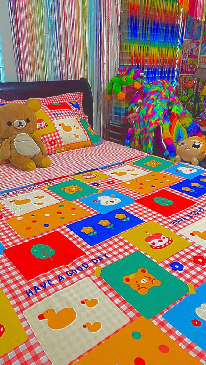 a teddy bear sitting on top of a bed in a child's room with colorful bedspreads