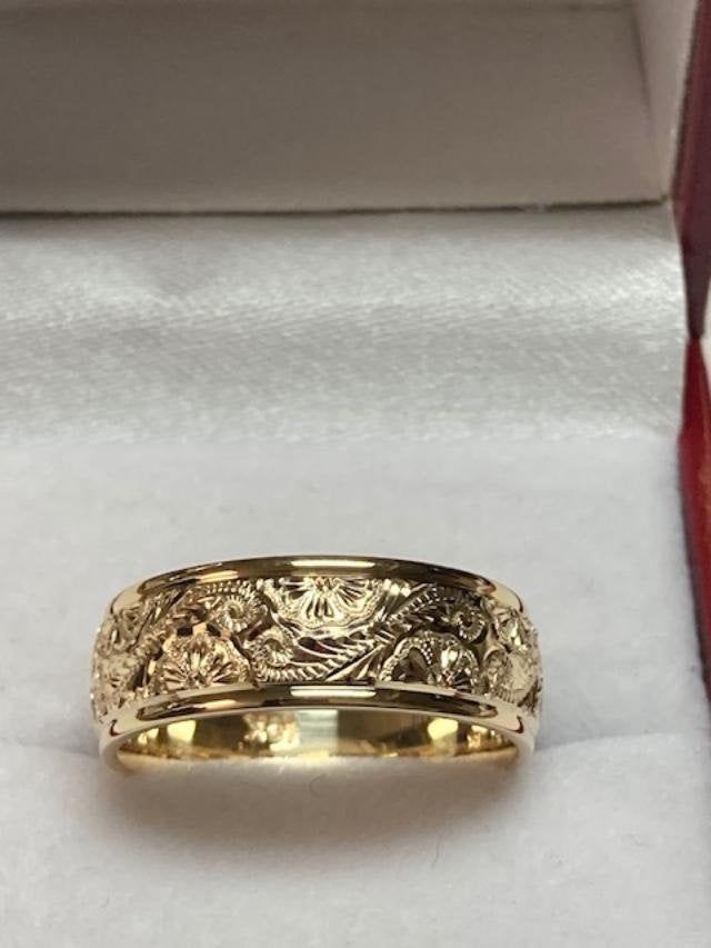 a gold wedding ring in a box