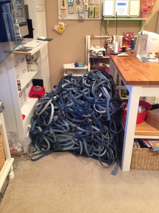 a pile of blue cords sitting on top of a floor next to a wooden table