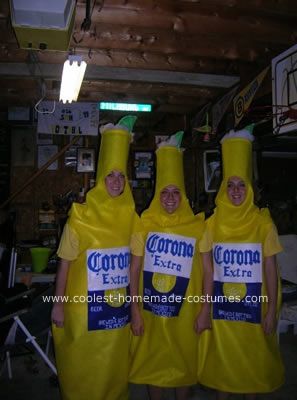 three people in banana costumes are standing together and wearing corona extra shirts on their heads