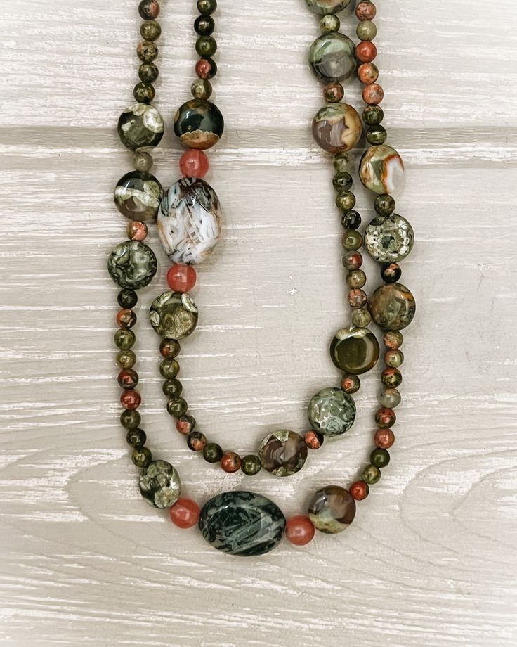 A necklace designed with variegated mossy-green beads and natural inclusions of peach, orange, and white. May be worn as a single or double strand. A copper toggle clasp is attached. Hand-strung Jasper Bead Necklaces, Green Ocean Jasper Necklace For Healing, Green Jasper Necklaces With Natural Stones, Earthy Green Jasper Necklaces, Bone Crafts, Necklace Ideas, Chunky Beads, Pretty Jewelry, Jewelry Pins