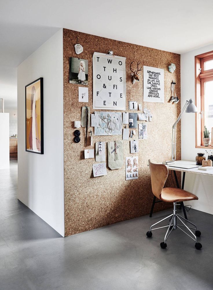 a home office with a cork board wall