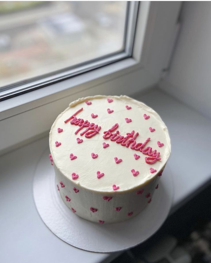 a birthday cake sitting on top of a window sill