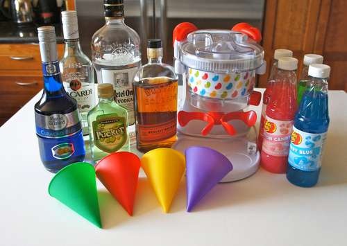 there are many different types of cocktails on the counter top, including bottles and funnel glasses