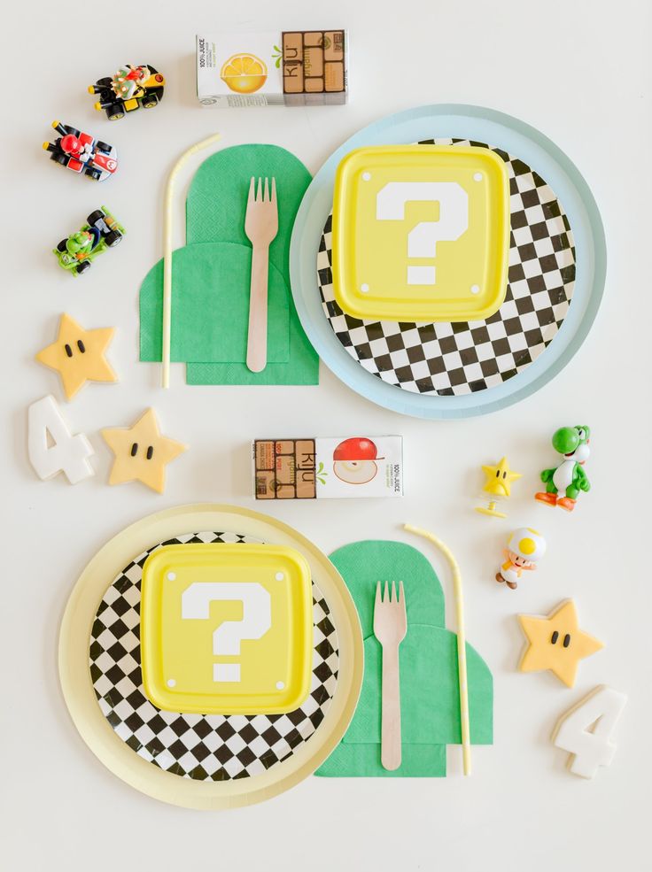 a table set up with plates, forks and candies