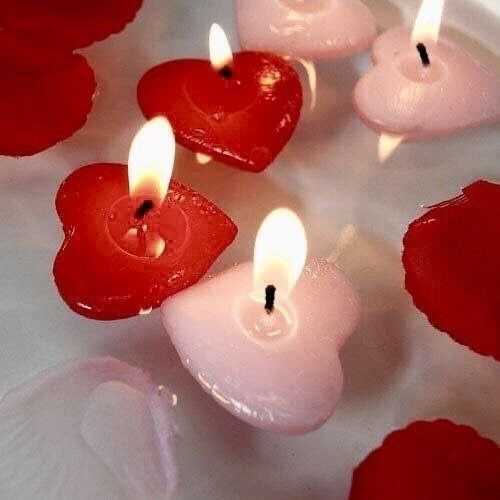 some red candles are in the shape of hearts