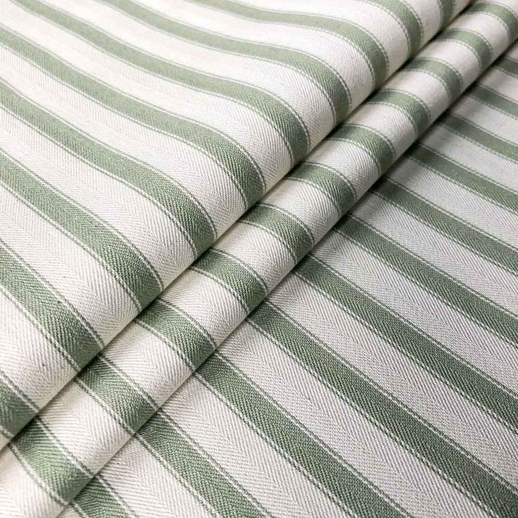 the green and white striped sheets are folded together