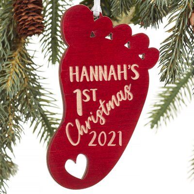 a wooden ornament hanging from a christmas tree with the words hannah's 1st christmas