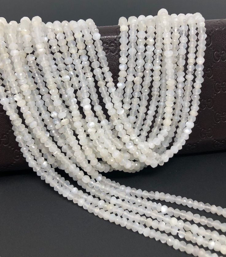 white beaded necklace on black leather case