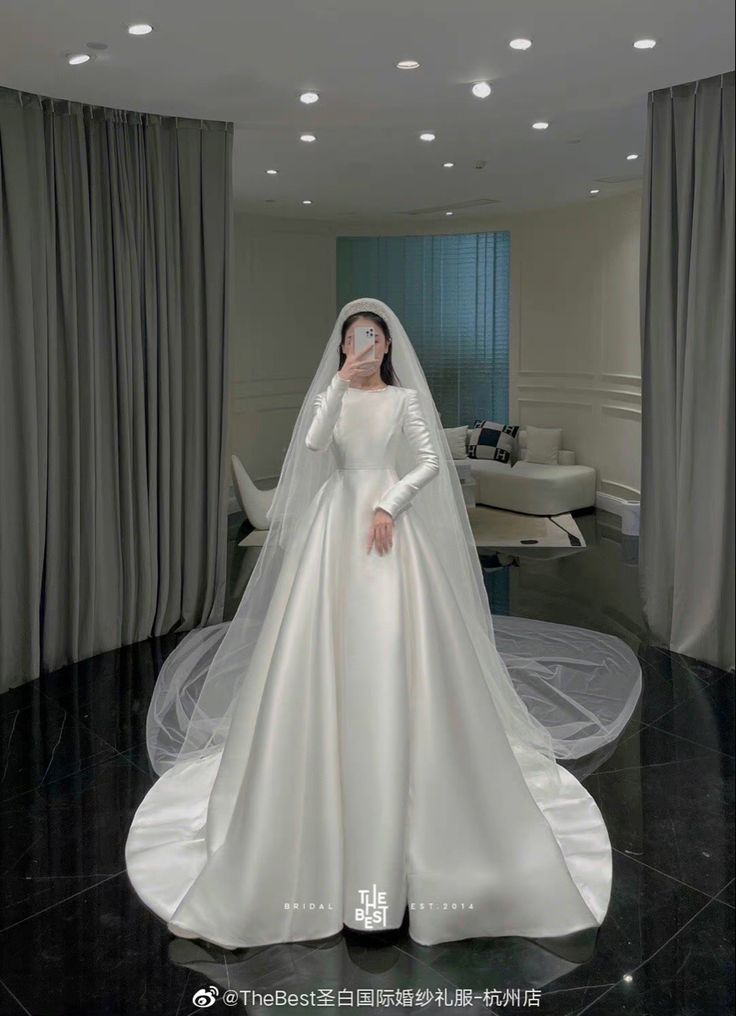 a woman in a white wedding dress and veil