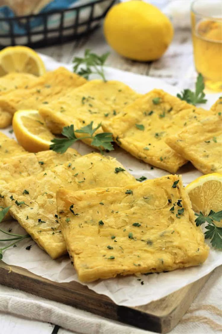 crackers with herbs and lemons on a cutting board