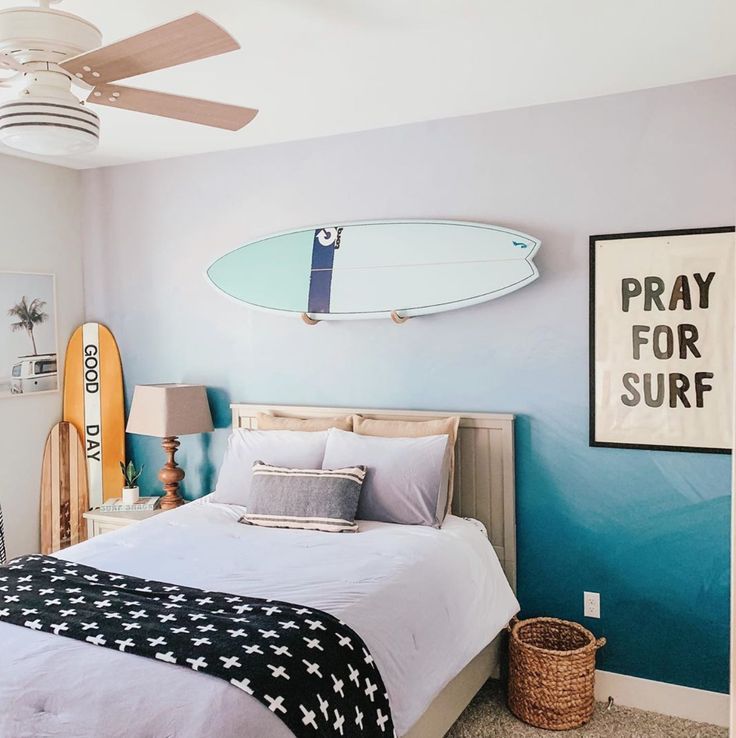 a bedroom with a surfboard on the wall