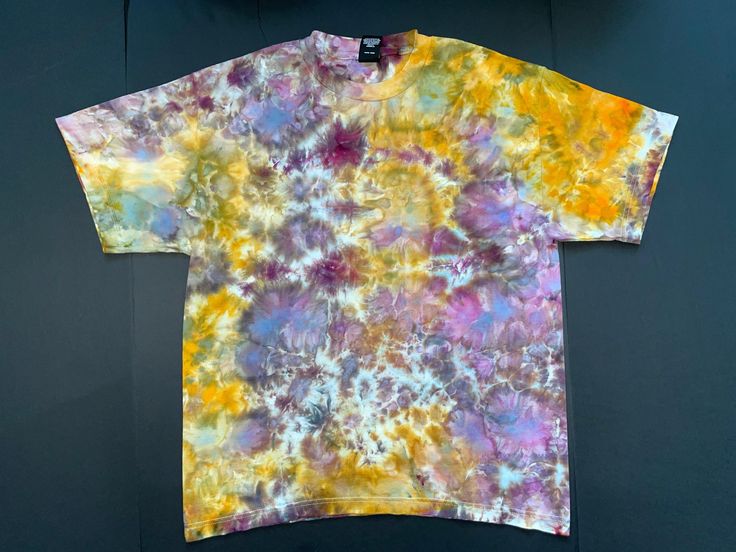 A custom designed and handmade tie-dyed t-shirt. The shirt is a high quality Hanes 6.1 oz Large made from soft, 100% ring-spun cotton.  The dyes we use are professional quality fiber reactive Procion dyes that resist fading after repeated washing. Hippie Hand Dyed Tie Dye T-shirt, Tie Dye Hippie T-shirt For Spring, Acid Wash Hand Dyed Hippie Top, Hippie Acid Wash Hand Dyed Top, Hippie Hand Dyed Short Sleeve Tops, Bohemian Tie Dye Short Sleeve T-shirt, Bohemian Hand Dyed Crew Neck T-shirt, Hippie Hand Dyed Festival T-shirt, Hand Dyed Hippie Short Sleeve T-shirt