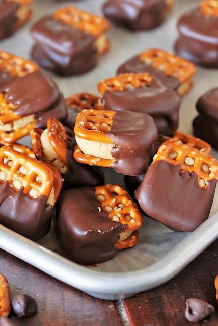 chocolate covered pretzels are arranged on a baking sheet and ready to be eaten