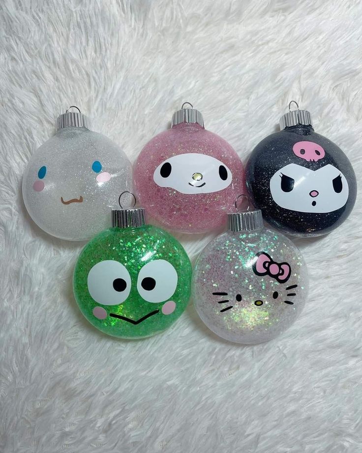 four ornaments with different designs on them sitting on a white furnishing surface in the shape of christmas balls