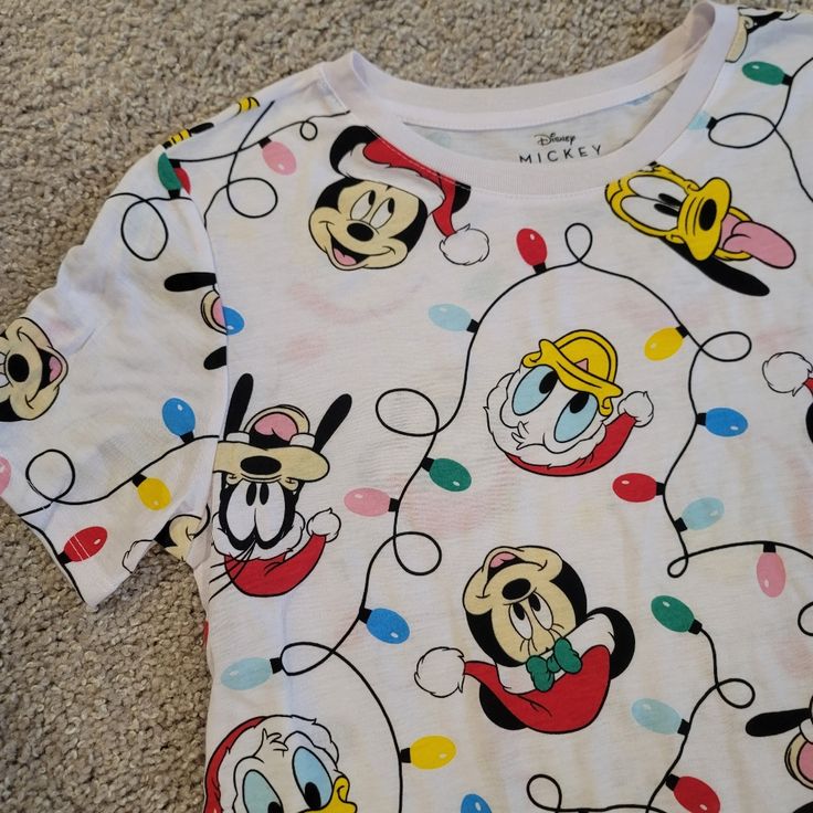 a mickey mouse t - shirt laying on the floor