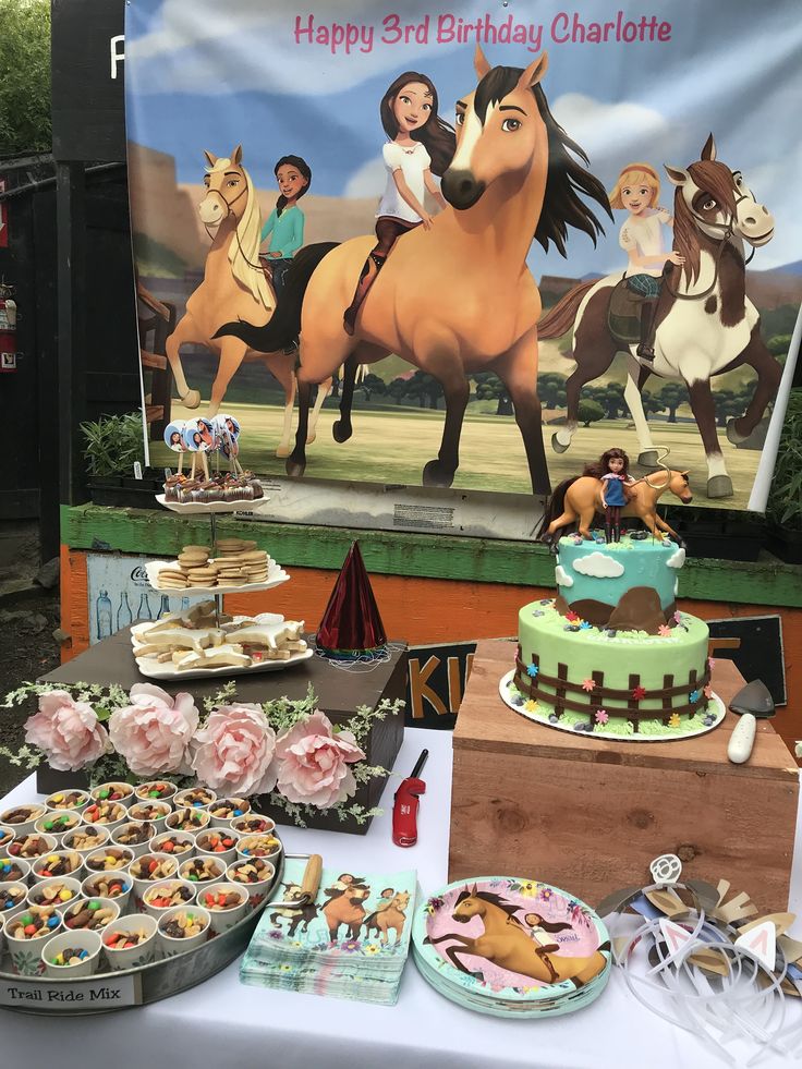 there is a horse themed birthday cake and desserts on the table