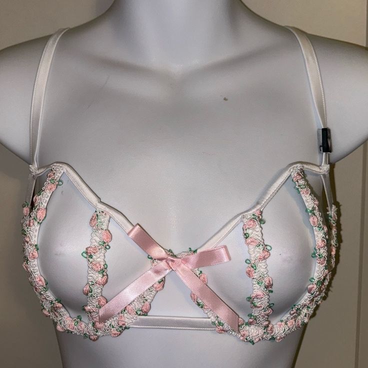 Secret Garden Collection What A Sexy Bra! Open Cage Style With Flexible Boned Rows Making Up The Cups. One Section Of Boning On The Sides, And Then The Back Is An Open Elastic Pattern. It Is Ivory On Color, With A Feminine Embroidered Floral Patterned Lace In Pink, Green And Ivory. Double Hook Back, 4 Rows For Size Adjustment. Silver Colored Hardware, Adjustable Elastic Shoulder Straps. Feminine Pink Bra With Delicate Straps, Pink Coquette Underwire Bra, Feminine White Bra For Party, Feminine White Party Bra, Victoria's Secret Pink Bra For Spring, Spring Bra With Delicate Straps, Feminine Party Bra, Victoria's Secret Bra With Built-in Support For Spring, Victoria's Secret Spring Bra With Lace Trim