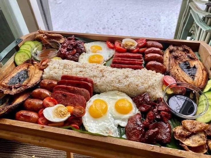 a wooden box filled with lots of different types of food on top of a table