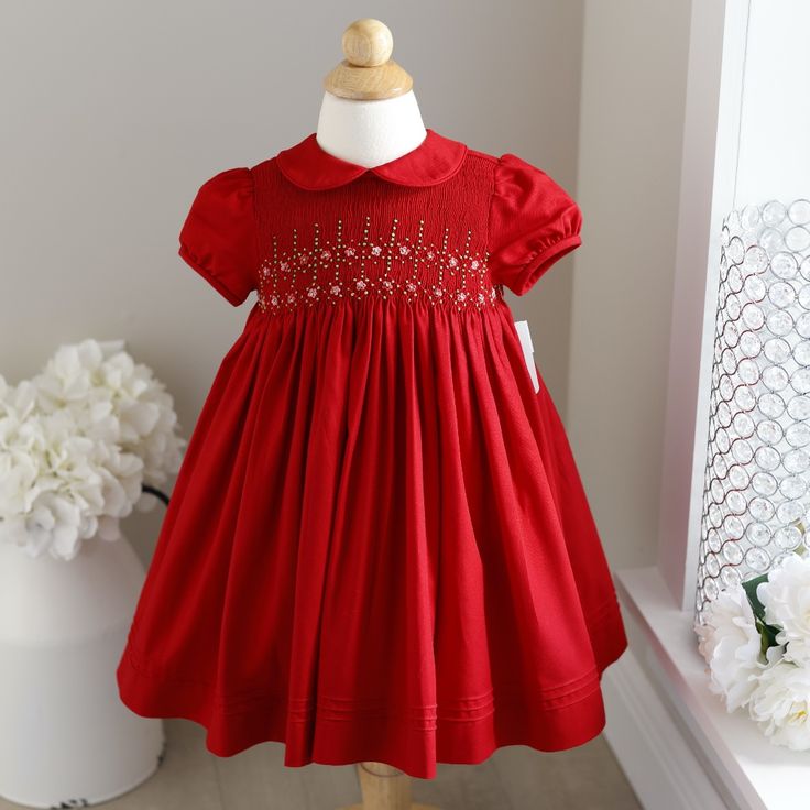 This Little Girl's Size 24 Months Dress By Luli & Me (Fine Children's Apparel) Is Adorable. The Dress Is Done In A Beautiful Red Hue And Has Embroidery In Shades Of Red, Pink And Green. The Entire Bodice Is Smocked In An Accordion Design. Two Horizontal Rows Of Diamond Shapes Are Done In Red Embroidery And Have An Embroidered Flower In Each One, Done In Different Shades Of Pink And Red. Hand-Embroidered Green Dots Outline Each Diamond Shape. Vertical Rows Of Green Dots Border Each Diamond And Ex White Floral Sundress, Float Dress, Hand Smocked Dress, Smocked Baby Dresses, Evergreen Garden, Girls Smocked Dresses, Smocked Clothes, Smocked Dresses