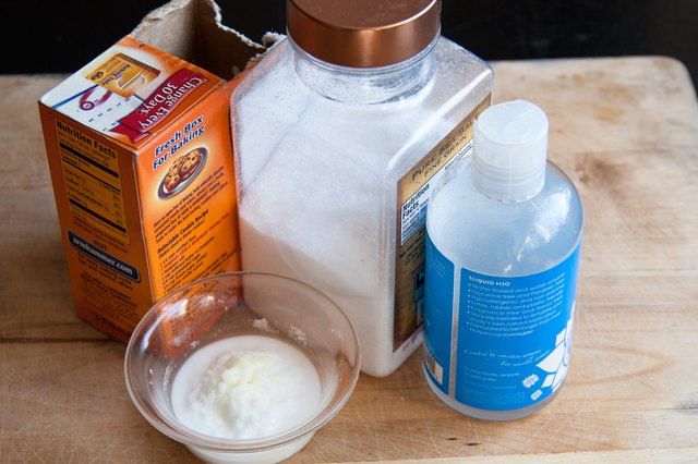 the ingredients to make an ice cream dessert are displayed on a cutting board, including milk and sugar