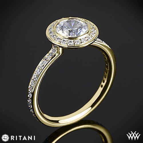 a gold ring with an oval shaped diamond surrounded by smaller round diamonds on the side