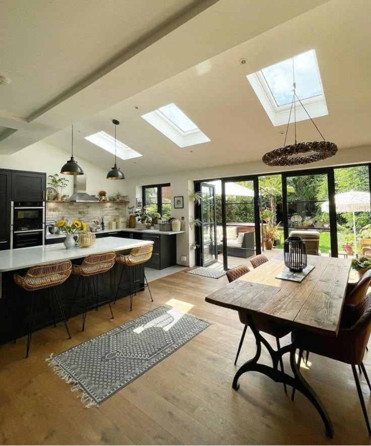 an open kitchen and dining room with skylights