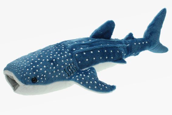 a stuffed shark toy laying on top of a white surface