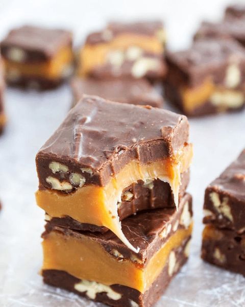 several pieces of chocolate and peanut butter fudge bars stacked on top of each other